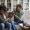 African american young man trying to calm down emotional crying woman during therapy session with family psychologist, black couple sitting on couch at therapist office. Breakup, divorce help concept
